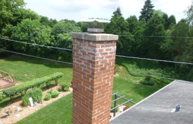 Home 9 Chimney with white stains indicating it needs tuckpointing.
